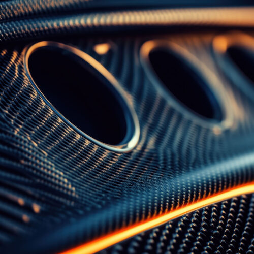 Close-up of carbon fiber texture with air vents. Illustrates lux